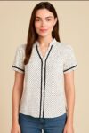Chic-white-polka-dot-blouse-with-black-piping-and-a-flattering-V-neckline.jpeg