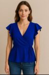 This vibrant royal blue wrap blouse features flutter sleeves and a flattering V-neckline, cinched at the waist with a delicate tie for a feminine silhouette